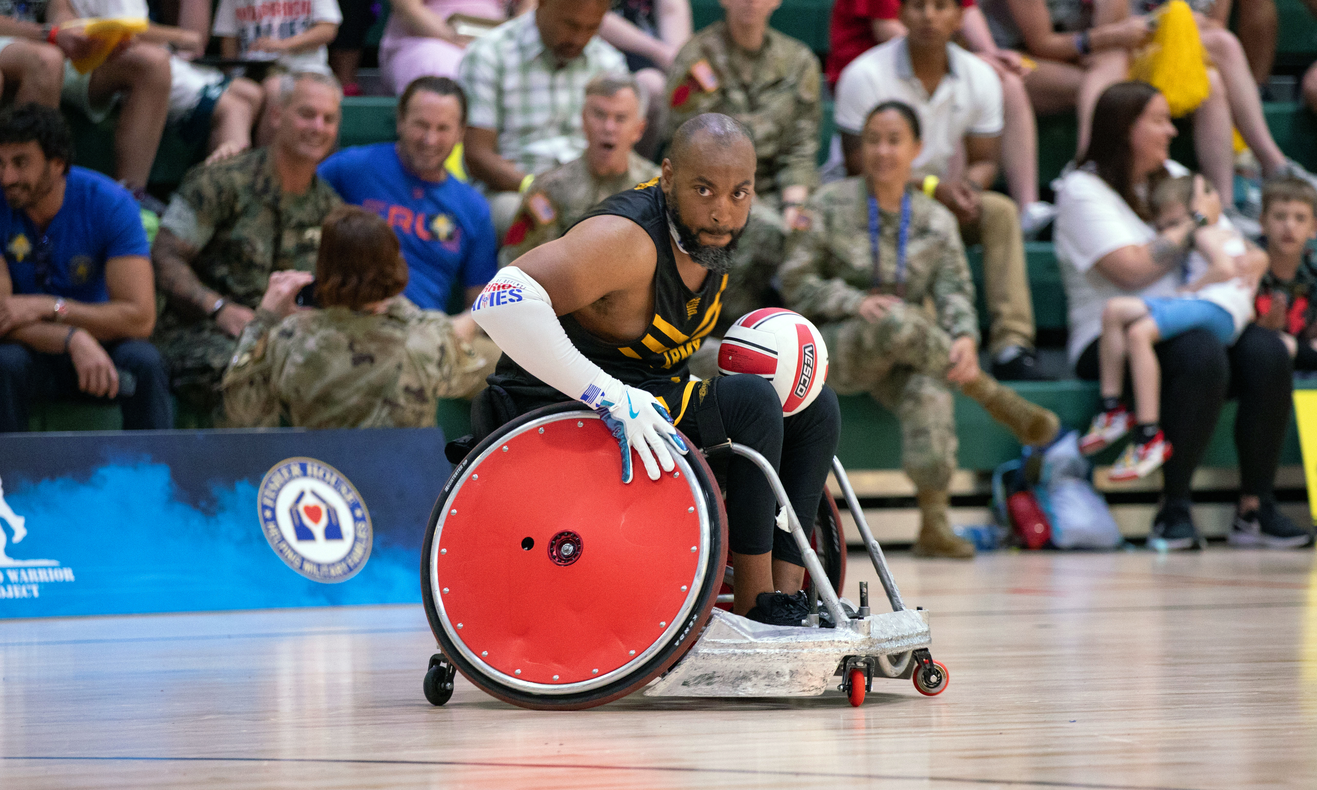 Participant participating in wheelchair basketball at the Warrior Games.
