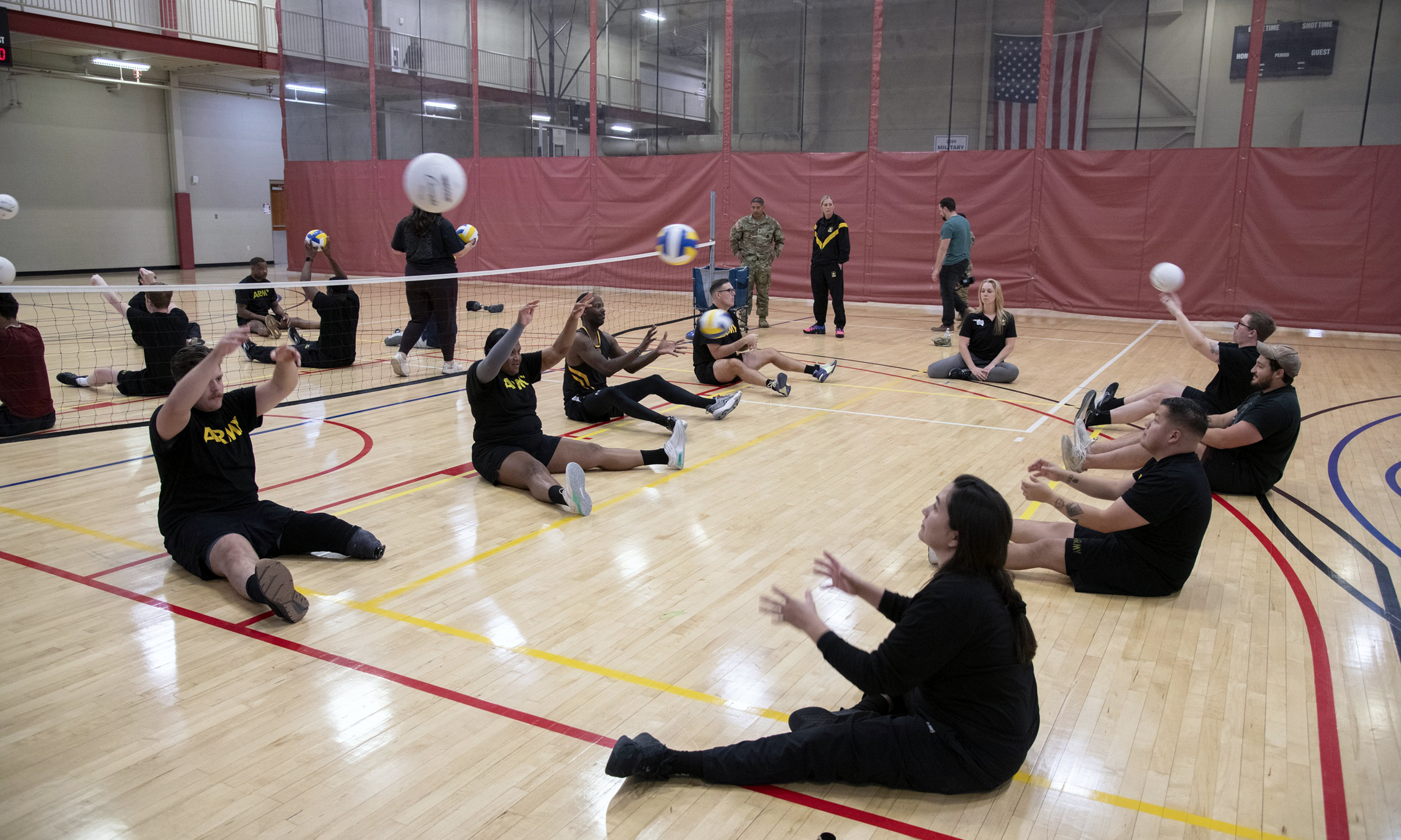 Army Trial participants playing sitting volleyball.